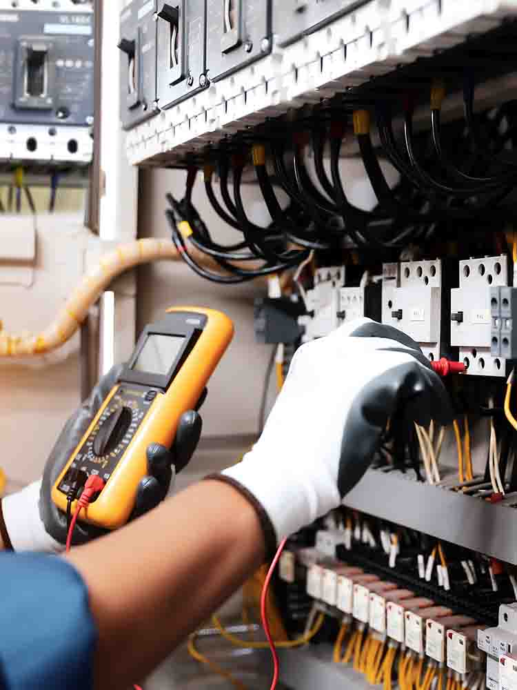 electrical tech checking fuses