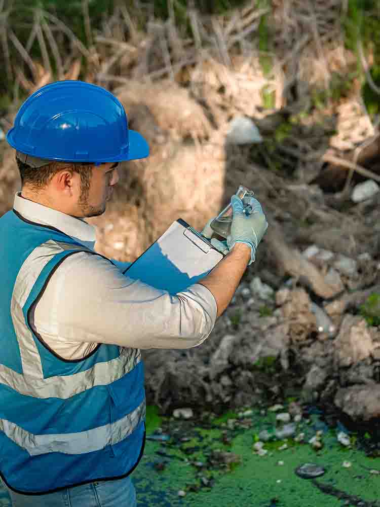 environmental health and safety worker collecting sample from water